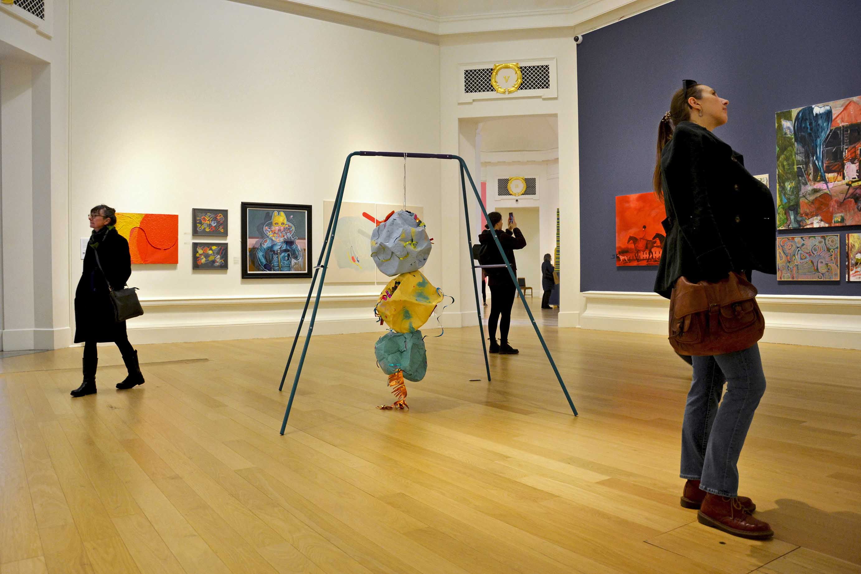 MADE TO WRECK, 2022 : Installed in the 196th Royal Scottish Academy Annual Exhibition - Steel swing set, curling ribbon, spray paint on papier mâché, slime, bouncing putty, party decorations