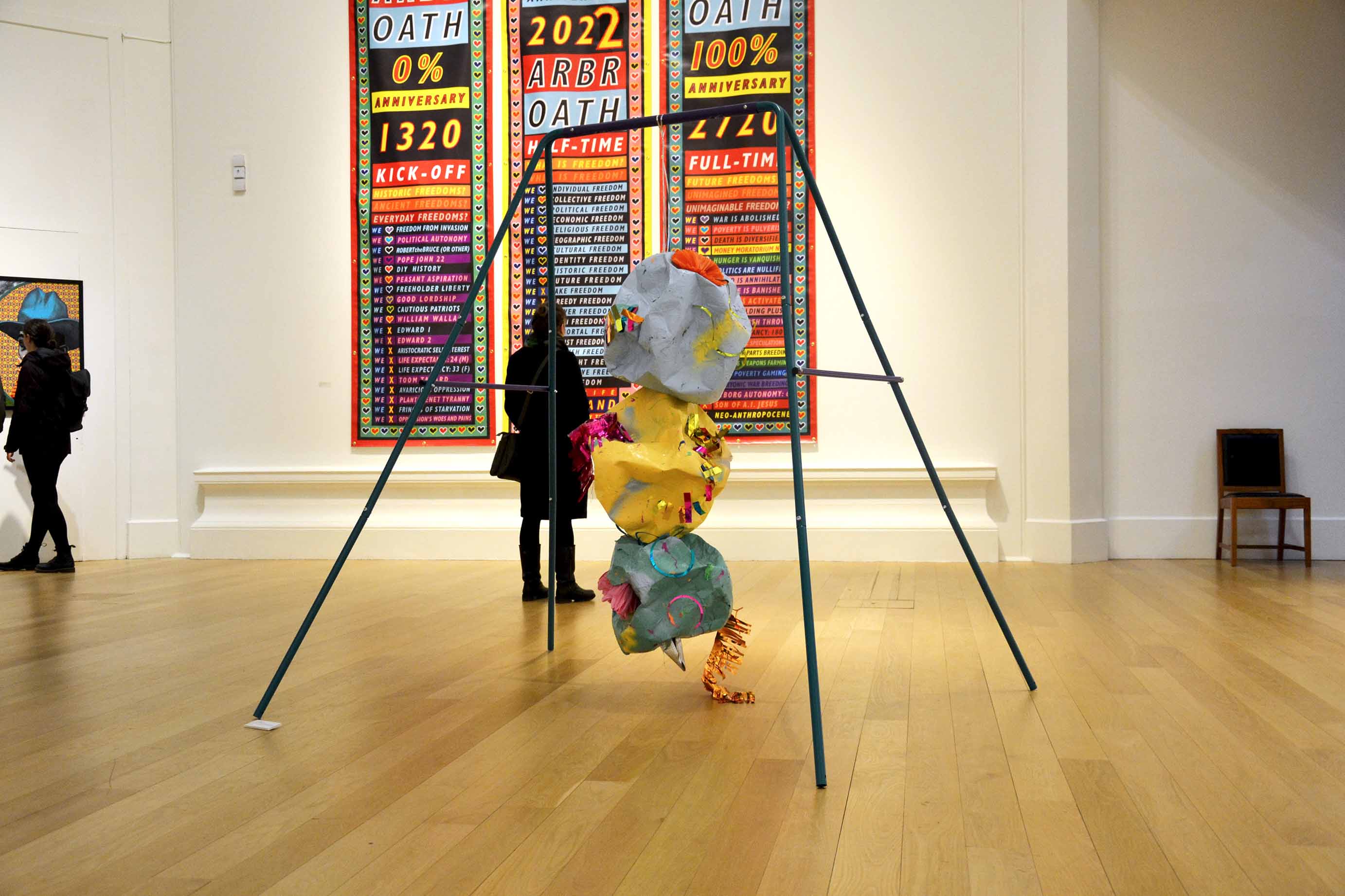 MADE TO WRECK, 2022 : Installed in the 196th Royal Scottish Academy Annual Exhibition - Steel swing set, curling ribbon, spray paint on papier mâché, slime, bouncing putty, party decorations