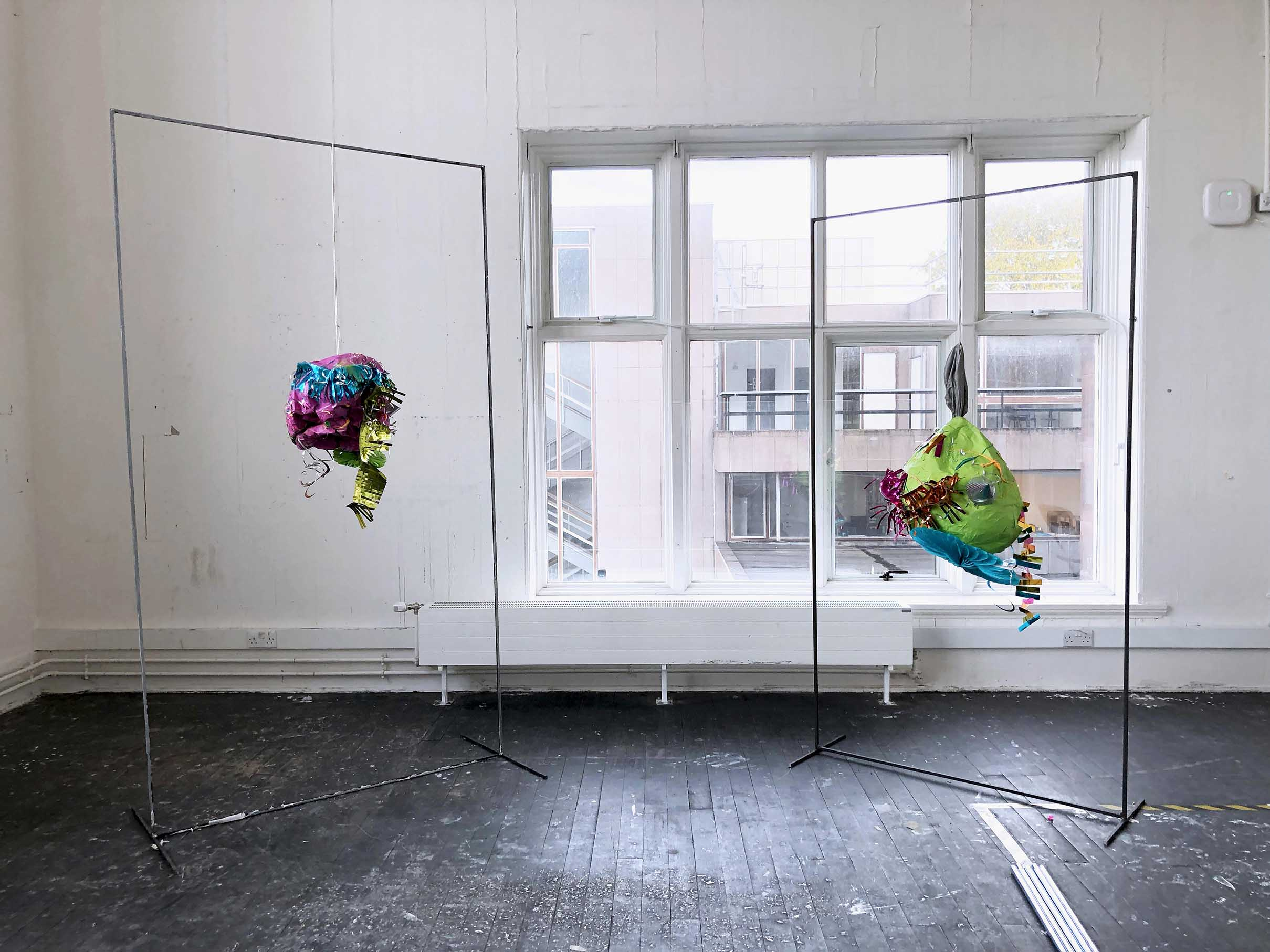 POTENTIAL FOR HAVOC, 2021 - Exterior: X2 metal frames, spray paint on papier mâché, slime, bouncing putty, party decorations / Interior: baked beans, glitter star bouncy balls