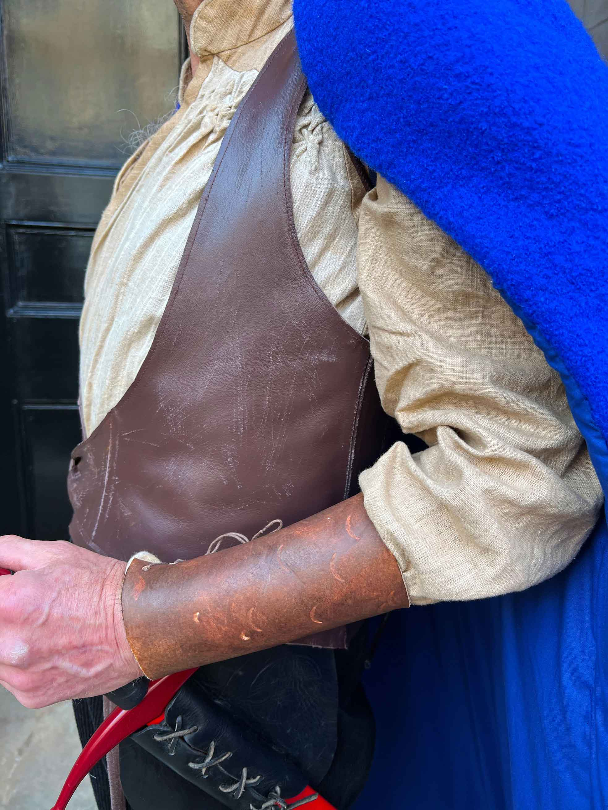 A detail shot of the costume, showing the bracer, waistcoat and shirt.