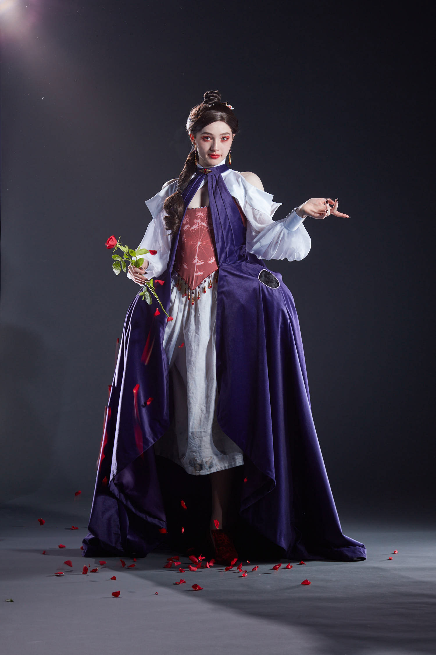 The costume created for the character Lacie from Pandora Hearts. The model wears a purple dress with a red corset, white skirt and sleeves. 